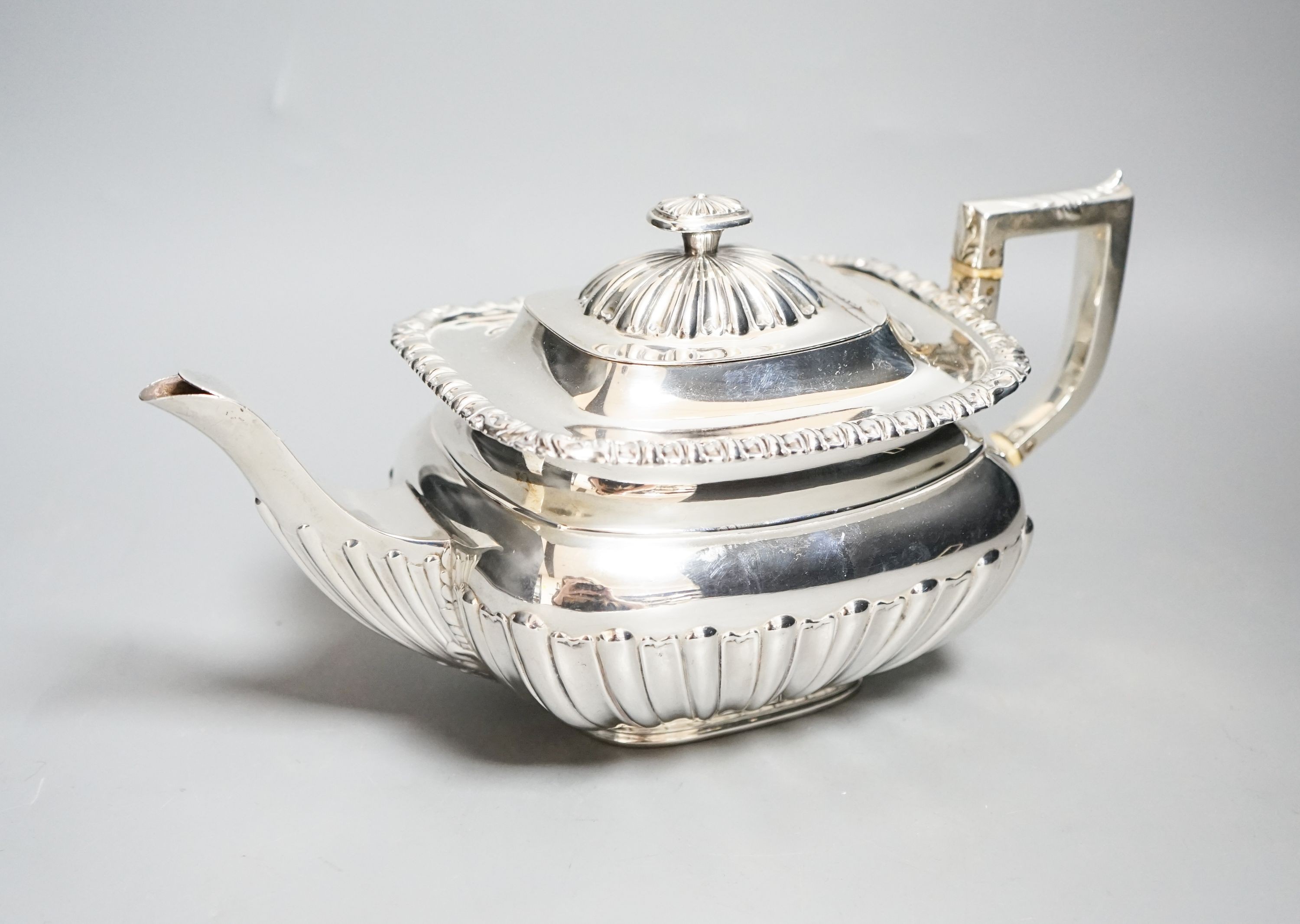 An Edwardian demi-fluted silver teapot, Sheffield, 1901, gross 22.5oz.